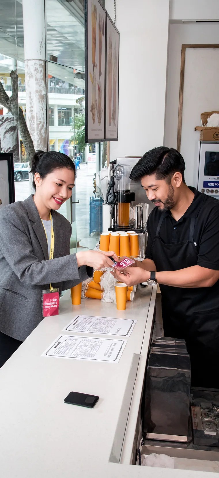 Café tenant and staff at a shopping centre unit