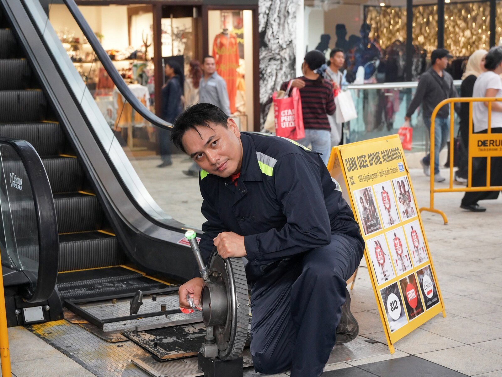 Chief engineer inspecting an escalator in a mall