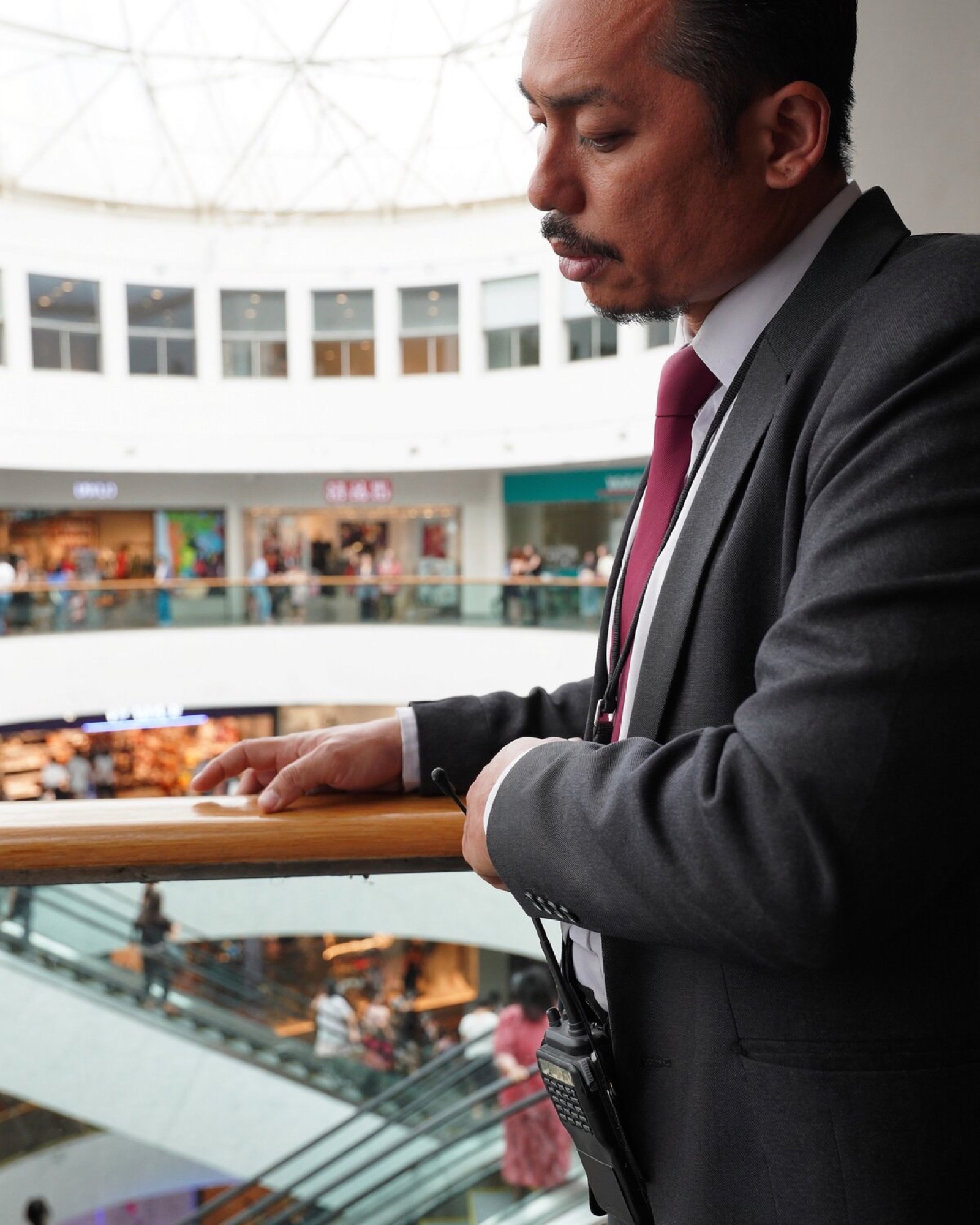 General manager checking a tenant report in a shopping centre.