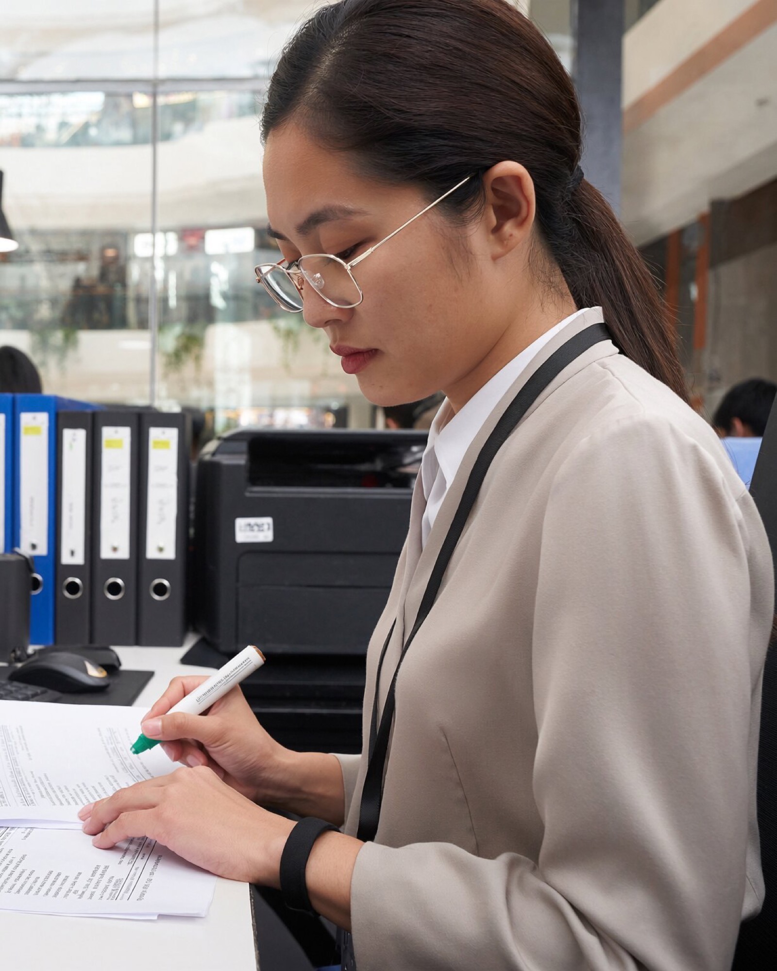 Finance colleague entering figures from a printed ledger.